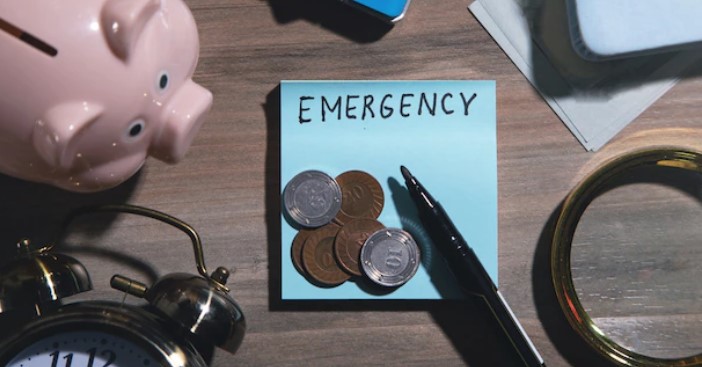 reserva de emergência: foto de cofre de porquinho, moedas, lupa, papel e caneta
