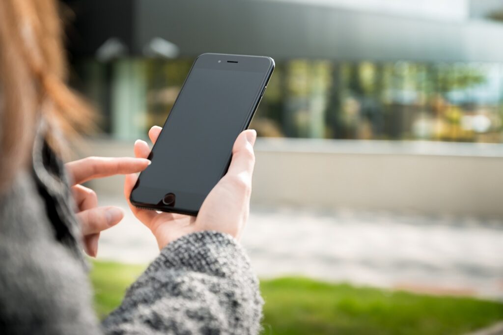 Imagem mostra uma mulher fazendo uma chamada de celular.
