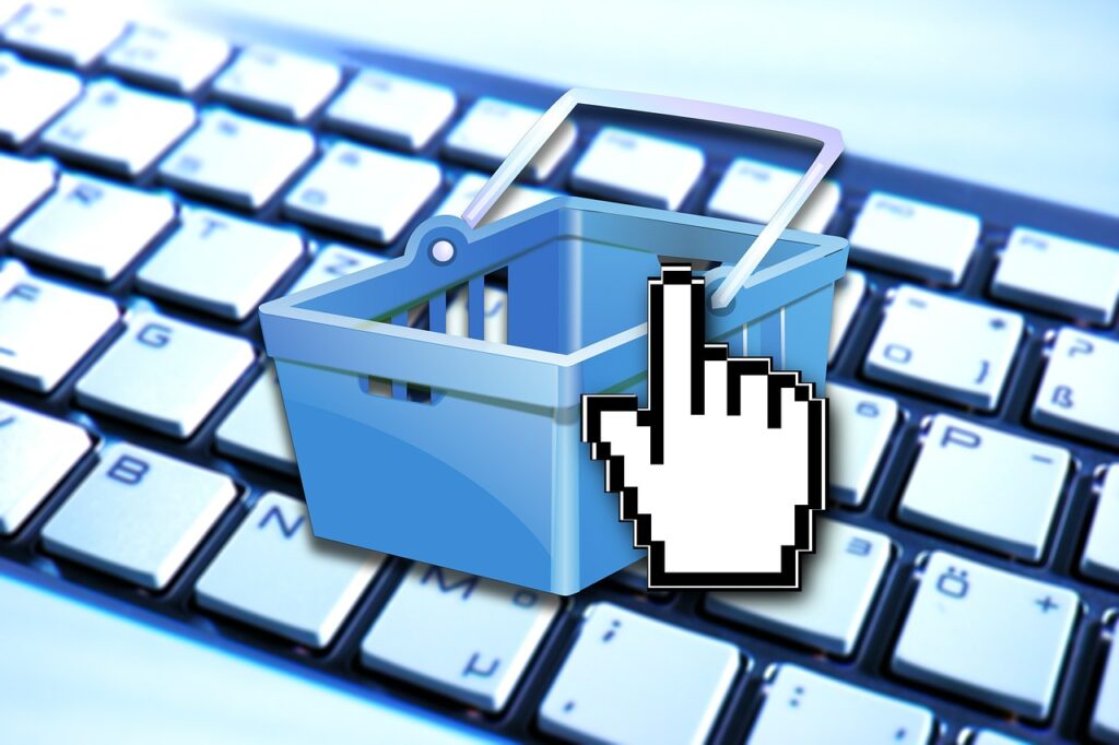 Imagem mostra uma operação de compra online, com os símbolos de informática na tela.
