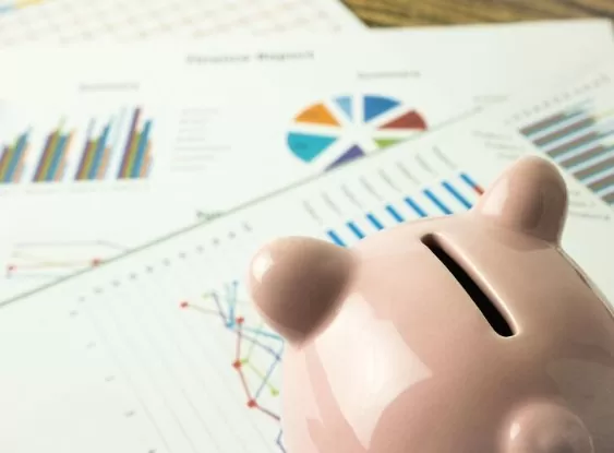 planejamento financeiro: foto de planilhas e cofre de porquinho